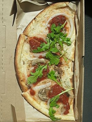 Half 11-inch Veg Out Pizza, made w/ classic dough, vegan cheese, mushrooms, onions, red sauce dollops + arugula at Blaze Pizza in Lincoln