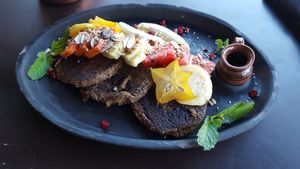 Vegan Mayan seed with plaintain and coconut pancakes. Fresh fruit, syrup. Quinoa is in the pancakes at Farm To Table in Tulum