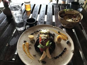 Breakfast, ramon pancakes with fruit, and seasonal bowl.  Cafe latte with coconut milk raw sugar.  at Farm To Table in Tulum