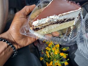 Chocolate layer cake. As good as it looks!! (Pericon flowers) at TNK Vegan Cafe in Modesto