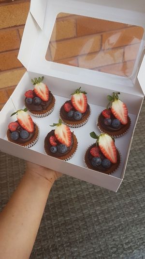 Vanilla cupcakes with chocolate ganache and berries at Sugar Baby in Dee Why