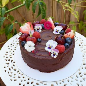 Chocolate cake with flowers and fruit at Sugar Baby in Dee Why