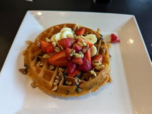 Vegan waffle with blueberries mixed in and strawberries, bananas, and walnuts on top at Waffles INCaffeinated in Beaver