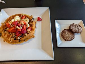Waffle with side of plant based sausage at Waffles INCaffeinated in Beaver