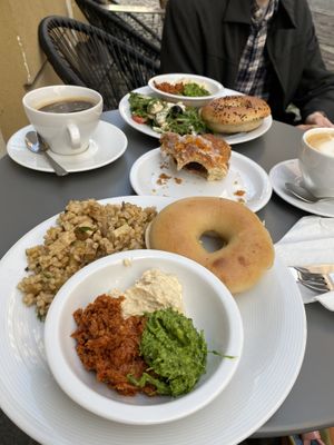 Vegan savory breakfast plate, vegetarian in the back, flat white, americano, vegan croissant  at Massolit Cooks in Krakow
