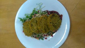 Baked millet cakes with couscous with cranberry sauce at Massolit Cooks in Krakow