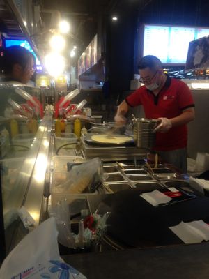 Hot Cakes making wraps process. This uses egg to make the wrap itself, so the meal is Vegetarian rather than Vegan. at Memorial Hall Underground Shopping Mall in Guiyang