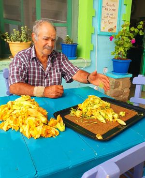 Panagiota's father stuffing courgette flowers. at Karavogianos in Lesvos