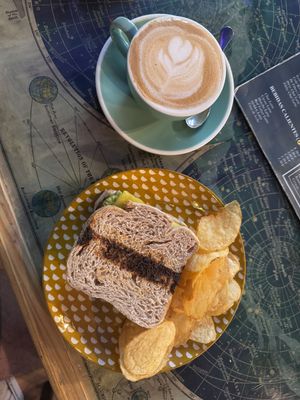 Toast of cheese, avocado and tomato with flat white   at La Tienda de Los Unicornios in Granada