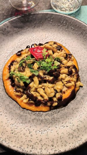 vegan gnocchi with porcini mushrooms & black garlic on a pumpkin cream sauce & crispy chips at Ristorante Lo Stornello in Stresa