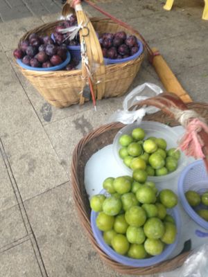 Examples of Green Plums and Purple Plums. at Guanshui Road Vegetable Sellers in Guiyang
