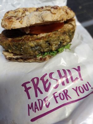 "Malzkornspitz", green oat patty with some spread and 1 tomato slice (4.90€) at Quicker's in Frankfurt