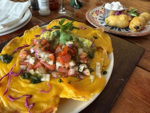 Vegan cheesy Nachos and Vegan chilli poppers in the background  at The Fat Cactus - Gardens in Cape Town