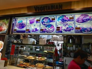 Stall front with daily specials listed in top pictures at Tien Teck Vegetarian in Central Singapore