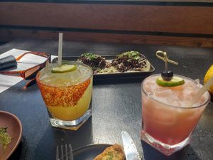 Hotter than Hell cocktail on left and Lime in the Coconut cocktail on right at Om Sabor in San Francisco