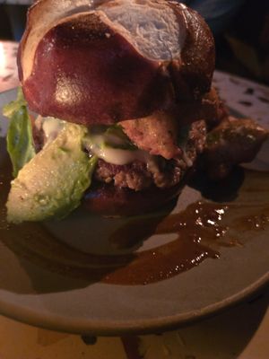 Burger with avocado, jalapenos, and crispy mushrooms at Om Sabor in San Francisco
