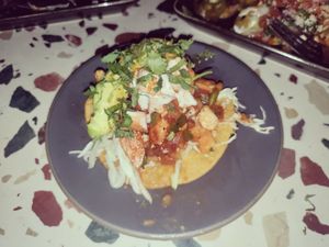 Tostada in bad lighting at Om Sabor in San Francisco