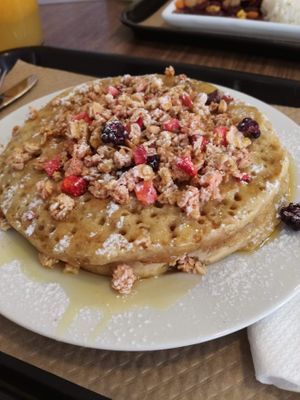 Vegan pancake with syrup, red fruits and granola at Biscoito in Porto