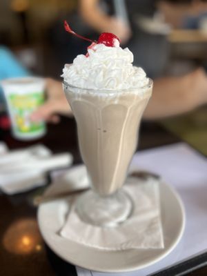 Chocolate milkshake, whipped cream and a cherry   at Ethos Vegan Kitchen in Winter Park