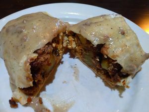 Breakfast burrito during Brunch. (Potatoes, tofu scramble and vegan sausage in a tortilla smothered with sausage gravy) at Ethos Vegan Kitchen in Winter Park