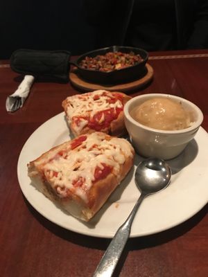 Vegan meatball sub with a side of the best mashed potatoes and gravy; in the back is the cornbread skillet at Ethos Vegan Kitchen in Winter Park
