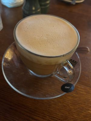 Oat coffee with sticker  at The Cosy Club in Ipswich