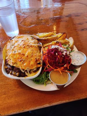 Chilaquiles enchilada, potato wedges and miso gravy, salad with poppy seed dressing at The Naam in Vancouver