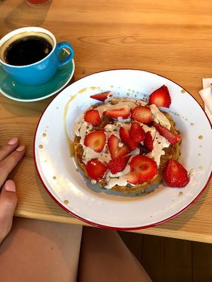 vegan waffle with maple syrup, strawberries, and coconut cream! at Hullabaloo in Ipswich