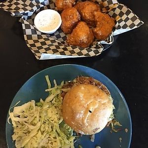 jackfruit sandwich with a side of slaw and buffalo cauliflower wings at The Wayside Cafe & Deli in Olympia