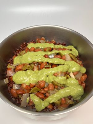 Rice and Beans Bowl: Green chile pinto beans and red rice, topped with our green chile pepita sauce. at The Wayside Cafe & Deli in Olympia