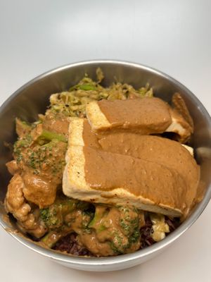 Dan Dan Bowl: Veggies sauteed in our sesame peanut sauce with spicy fried tofu and sesame slaw served over red rice. at The Wayside Cafe & Deli in Olympia