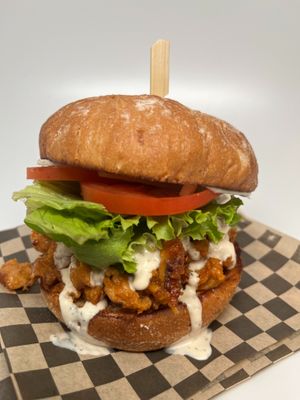 Buffalo Chickn Sandwich: Buffalo chickn style soy curls with lettuce, tomato, onion, pickles, and smothered in our house made ranch dressing on a toasted bun.  at The Wayside Cafe & Deli in Olympia