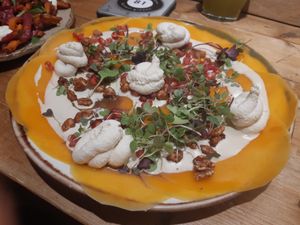 Roasted pumpkin carpaccio with plant-based cheese at Honest Greens - Hortaleza in Madrid