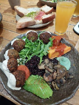 Wild Mediterranean with falafel and hummus to share at the backgroud at Honest Greens - Hortaleza in Madrid