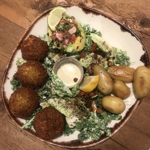 Kale vegan ceasar salad, falafel, avo and potatoes  at Honest Greens - Hortaleza in Madrid