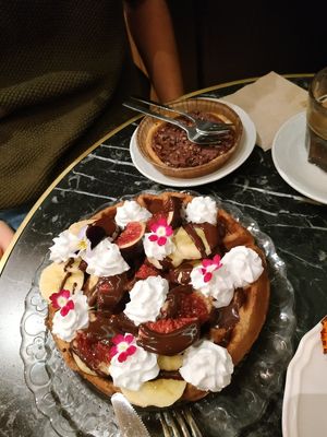 Hazelnut and dark chocolate tartalete. Buckwheat flour waffle with dark chocolate and fresh fruit at Bombon in Madrid