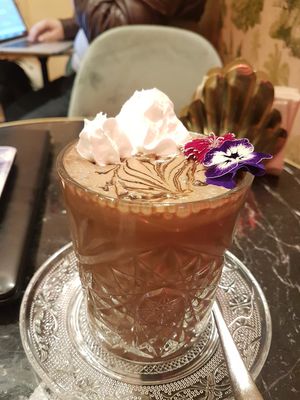 Cold chocolate with hazelnut milk, caramel and flowers at Bombon in Madrid