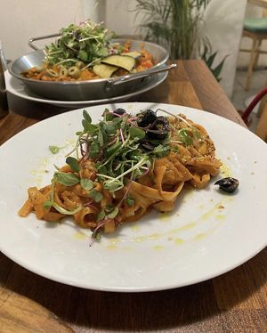 Rosé pasta topped with microgreens and black olives at Nammi Plant Lab in Seoul