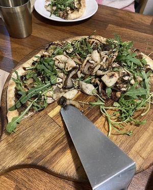 Incredible mushroom pizza - includes vegan pesto and ricotta, variety of cooked mushrooms, and topped with fresh arugula  at Nammi Plant Lab in Seoul