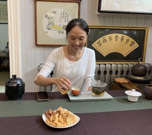 Yuan Jie, the owner, giving me free tea and accompanied sweets at Taiping Old Farm  in Beijing