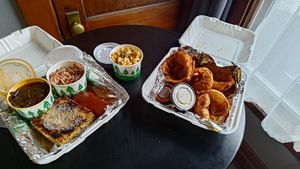 Collard greens, cole slaw, mac, corn bread, jackfruit ribs, onion rings. at Trio Plant-Based in Minneapolis
