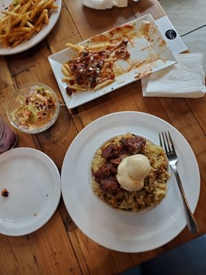 Chili cheese fries in the center, Soul Food bowl at the bottom at Trio Plant-Based in Minneapolis