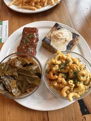 Soul food platter with ribs, corn bread, Mac and cheese, and collard greens   at Trio Plant-Based in Minneapolis