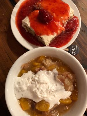 Peach Cobbler and Vanilla Cake with Strawberry Sauce - both are phenomenal  at Trio Plant-Based in Minneapolis