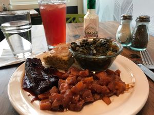 Soul food platter - sweet potatoes, bbq ribs, collards, corn bread at Trio Plant-Based in Minneapolis