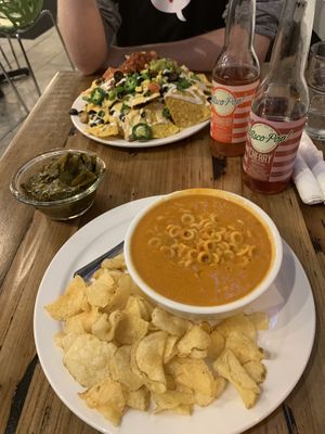 Spaghet-Trios, side of collards, and nachos. Wisco-pop is tasty + full of sugar. at Trio Plant-Based in Minneapolis