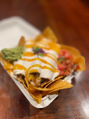 Nach-iladas Encremadas, from our Nach- Section enchiladas drenched in our crema and drizzled with queso fundido, plated with pico de Gallo & guacamole. Served over classic nachos. at Luna Verde Vegan Mexican Restaurant in Bradley Beach