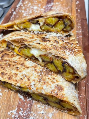 Quesadilla de Plátano Maduro | fried sweet plantain quesadilla with queso fundido & crema for dipping. at Luna Verde Vegan Mexican Restaurant in Bradley Beach