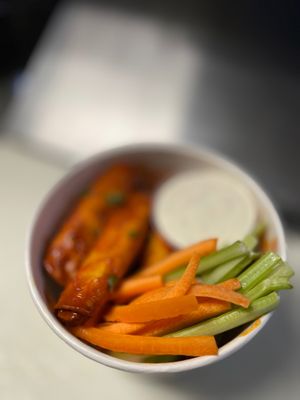 A L I T A Q U I T O S  in a bucket. Tempeh taquitos dorados tossed in seasoned spiced sauce ( buffalo style) served with vegan dressing ( choice of : ranch, bleu or crema ) at Luna Verde Vegan Mexican Restaurant in Bradley Beach