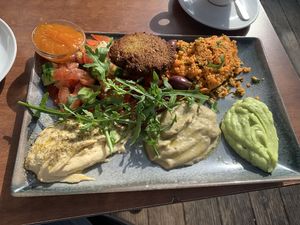 Startes platter with avo & eggplant spread and hummus, couscous, veggies…, plus jam for the sweet itch (not normally part of the dish)  at An-Do in Vienna